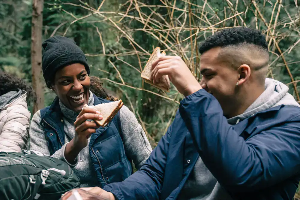 Friends laughing and sharing a meal at the adventure park cafe
