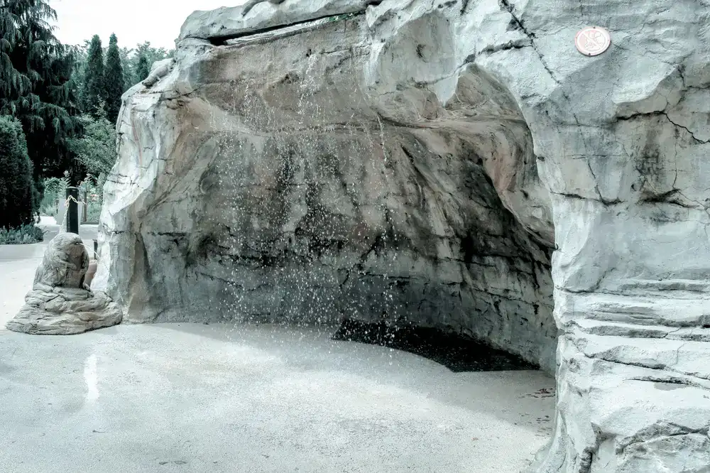 Mini-golf hole inside a rocky cave with an active waterfall feature